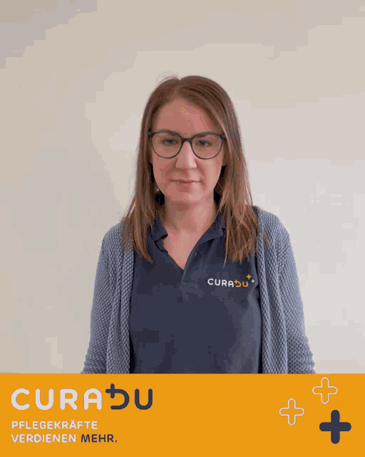 a woman wearing glasses and a curadu shirt