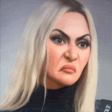 a woman with blonde hair and a black shirt that says lemon