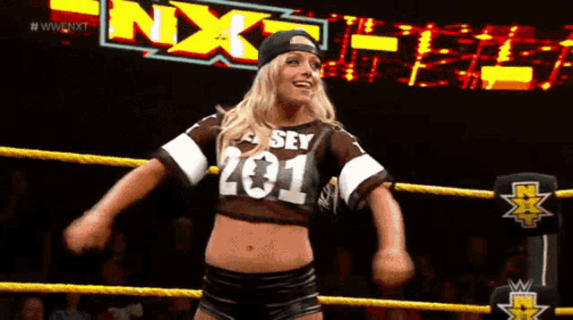 a woman in a wrestling ring wearing a shirt that says 201