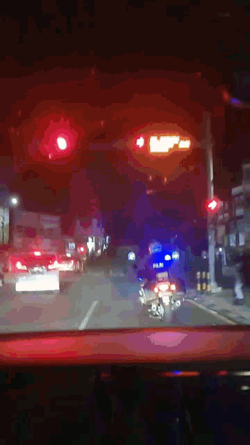 a car is driving down a street with a red light on
