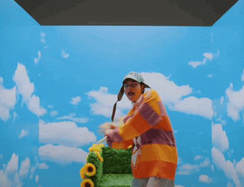 a person is holding a bunch of sunflowers in front of a blue sky