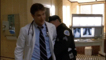 a doctor and a police officer are walking in a hospital room