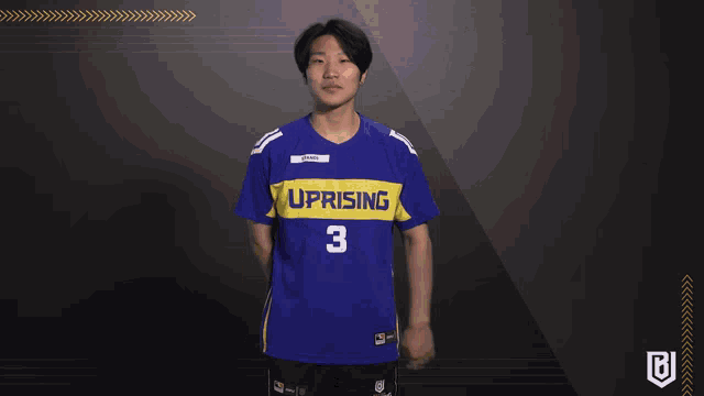 a man wearing a blue shirt that says uprising on it