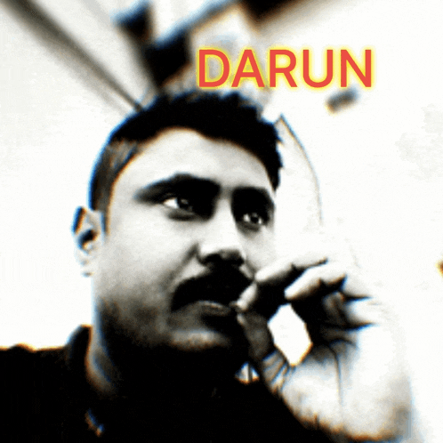 a man with a mustache is smoking a cigarette and the name darun is visible above him