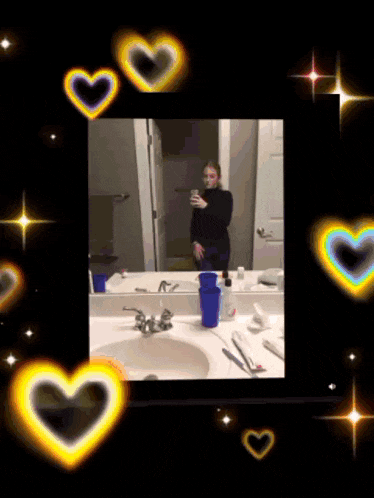 a picture of a woman taking a selfie in a bathroom