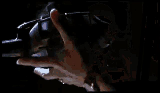 a close up of a woman 's face in a dark room with a shadow on her face .