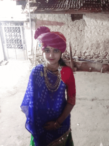 a girl wearing a turban and a blue and red dress