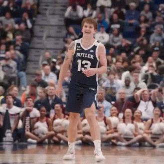 a basketball player wearing a butler jersey is standing on the court .