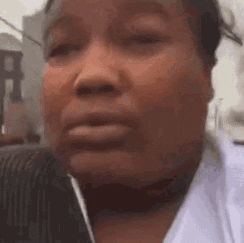 a close up of a woman 's face with tears running down her face .