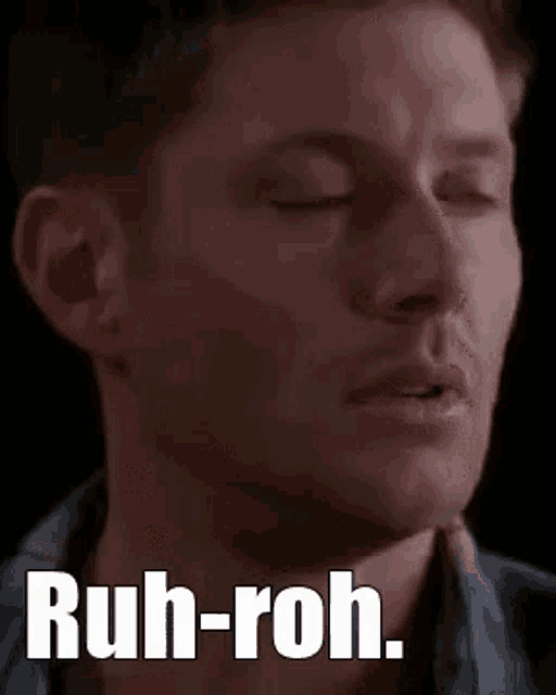 a close up of a man 's face with the words `` ruh-roh '' on it .