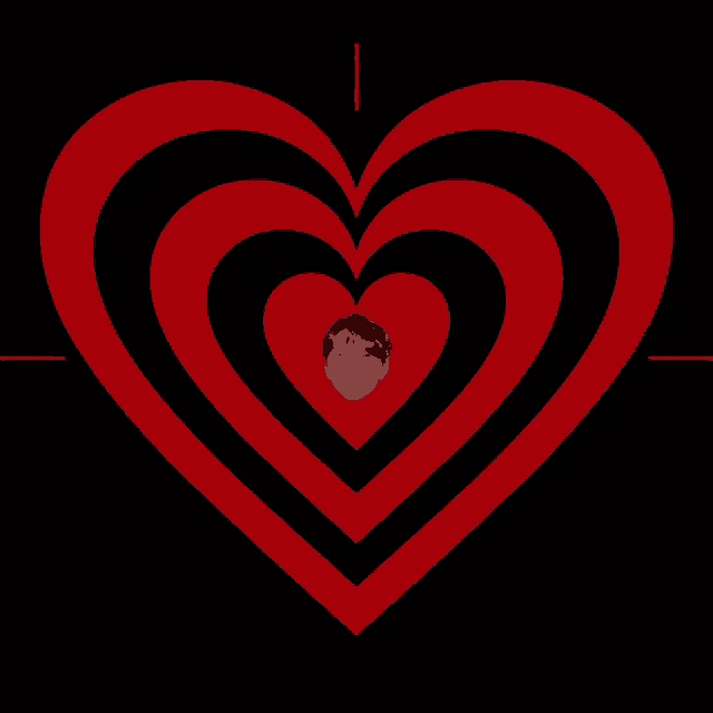 a red and black heart with a person 's face in the center