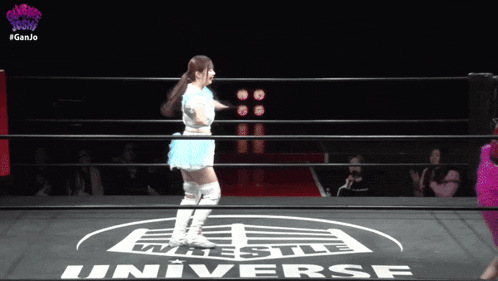 a woman in a wrestling ring with the word universe on the ground