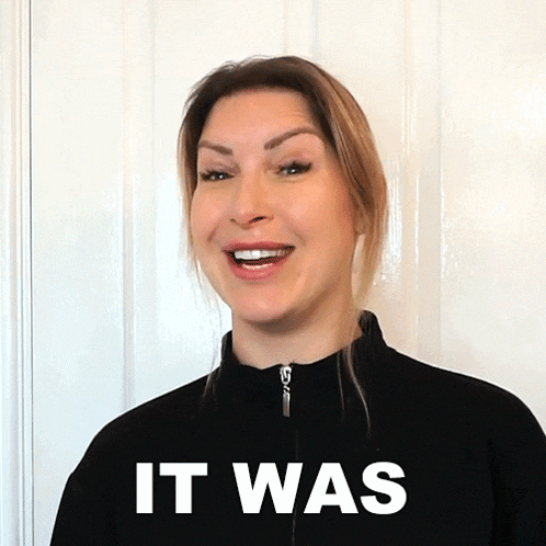 a woman wearing a black jacket with the word it was written on it