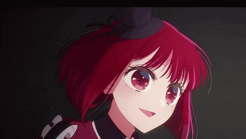 a girl with red hair and blue eyes is smiling in a dark room .
