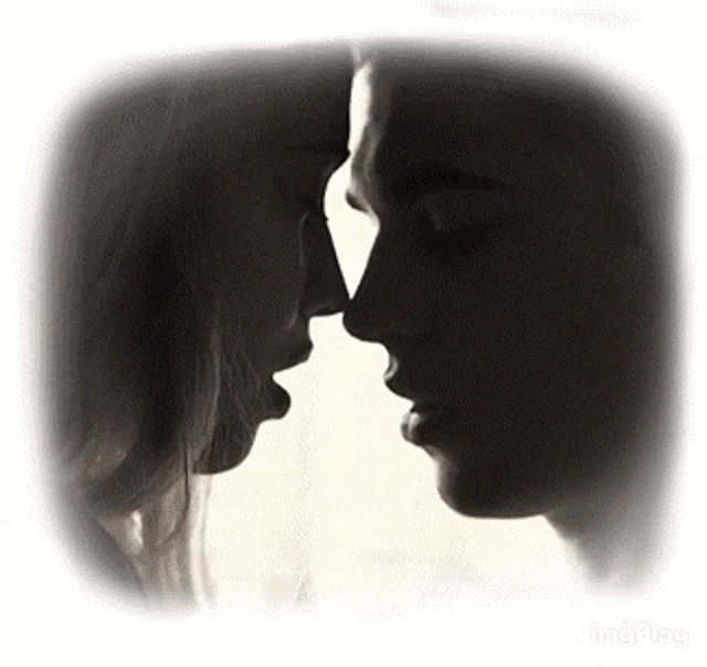 a man and a woman are looking at each other