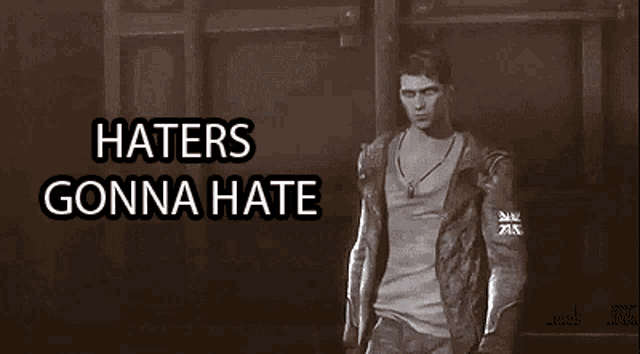 a man in a jacket stands in front of a wall with the words haters gonna hate above him