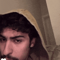 a man with a beard is wearing a yellow hoodie