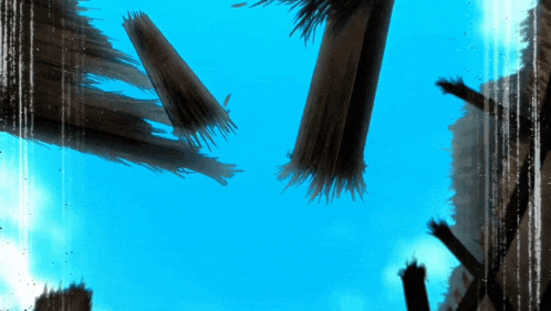 a blue sky with a few brushes flying in the air