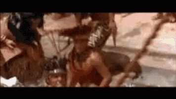 a group of people are standing in a pool .