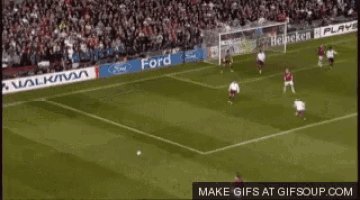 a soccer game is being played in front of a large crowd with a banner for ford on the sidelines