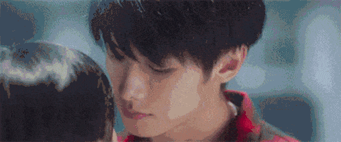 a close up of a man 's face with a woman 's head behind him .
