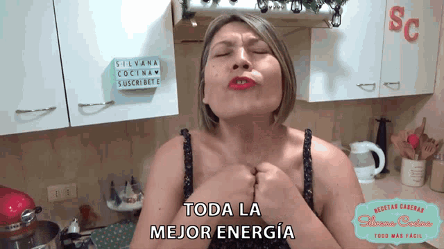a woman is in a kitchen with a sign that says silvana cocina suscribete