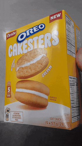 a box of oreo cakesters is being held by someone