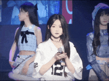 a girl wearing a white shirt with the number 12 on the front