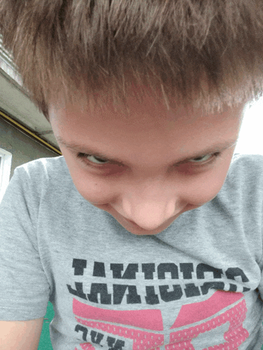 a boy wearing a t-shirt that says " i am a ninja "