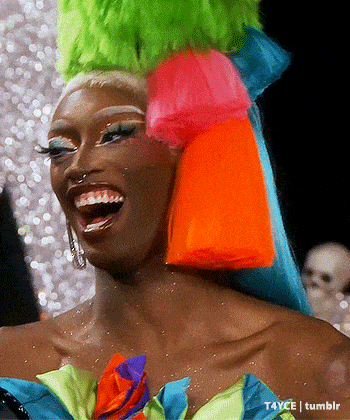a close up of a woman wearing a colorful wig