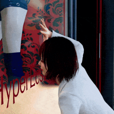 a woman looks at a mannequin in a store window that says hyper lus