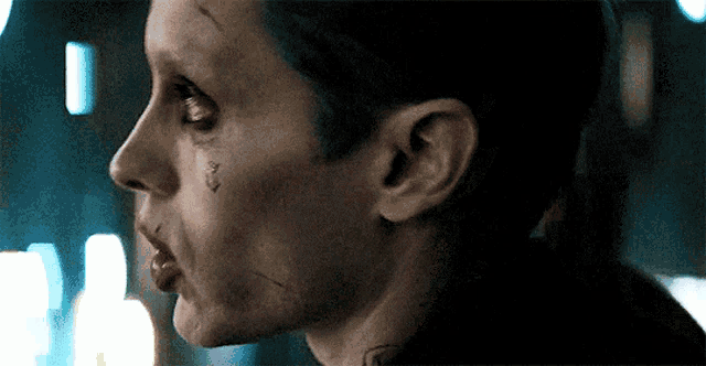 a close up of a person 's face with a tattoo on their face