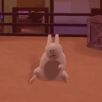 a white rabbit is sitting on the floor in a room with a fence in the background .