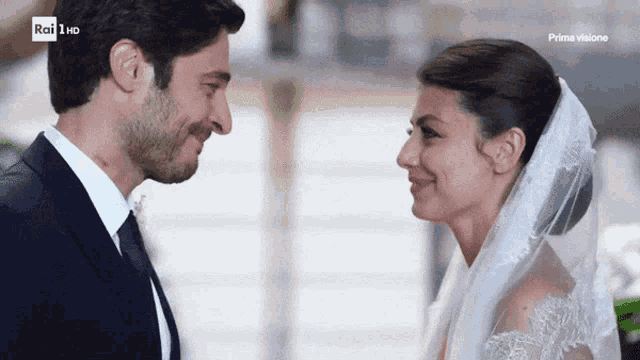 a bride and groom are looking into each other 's eyes with rai 1 hd in the corner