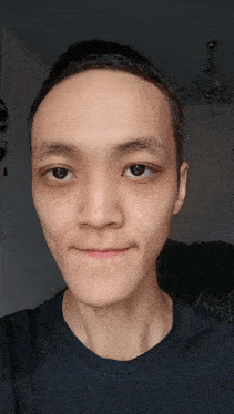 a close up of a man 's face with a sign in the background that says ' a ' on it