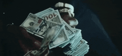 a man is holding a large stack of money in his hand .
