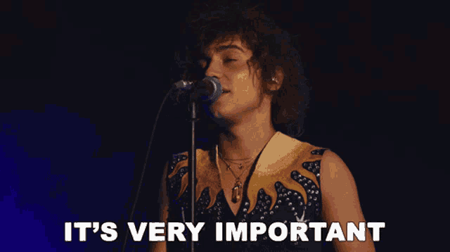 a man singing into a microphone with the words " it 's very important " next to him