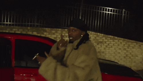 a man wearing a fur coat and a black hat is sitting in a car