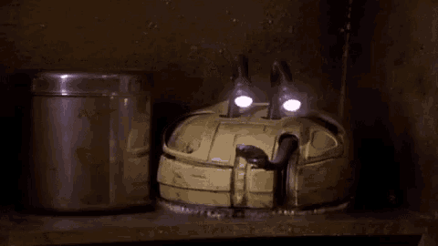 a container with a red heart on it sits on a shelf next to a robot