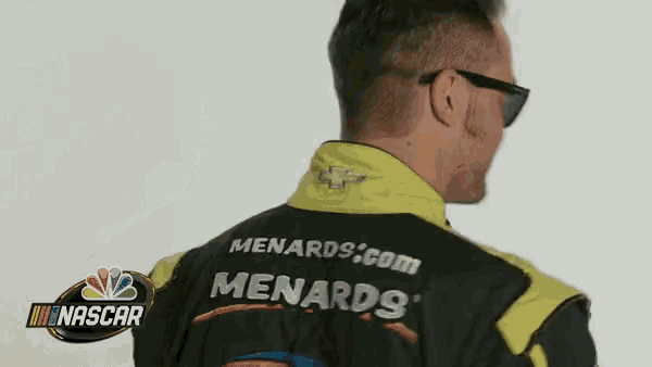 a man wearing sunglasses and a menards jacket