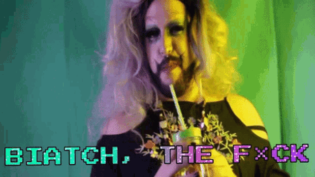 a drag queen is holding a drink with a straw and the words biatch the f * ck are displayed