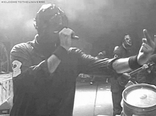 a black and white photo of a man singing into a microphone with the words welcome to the universe above him