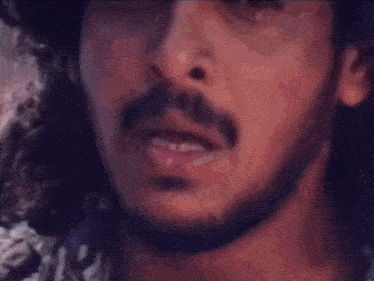 a close up of a man 's face with a blurred background