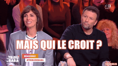 a man and a woman are sitting in front of a sign that says mais qui le croit ?