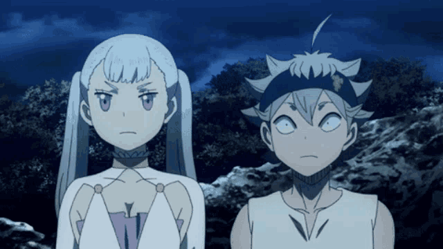 a boy and a girl are standing next to each other in a dark forest