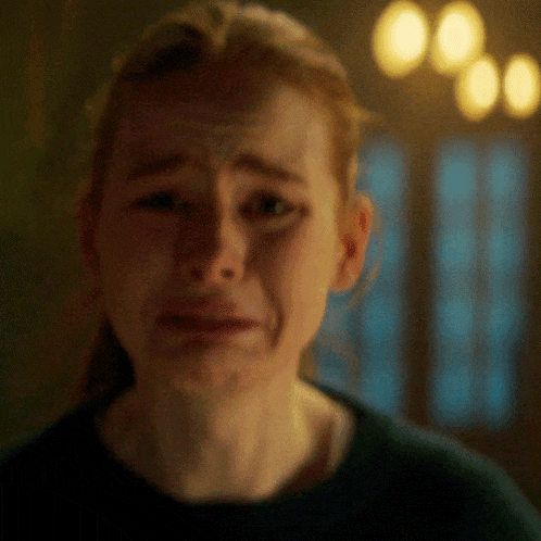 a close up of a woman 's face with a tear running down her face