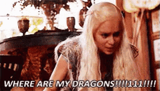 a woman with long blonde hair is sitting in a room and saying where are my dragons !!!