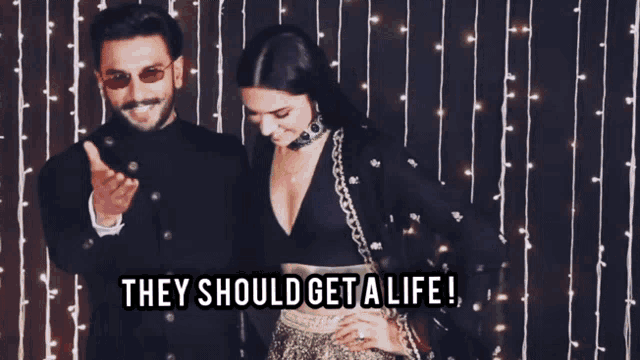 a man and a woman standing next to each other with the words " they should get a life " on the bottom