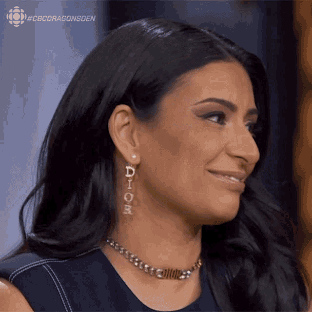 a woman wearing a dior necklace and earrings smiles