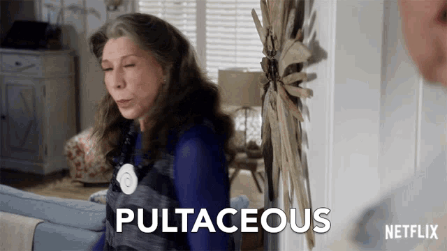 a woman is sitting on a couch and the word pultaceous is on the screen behind her